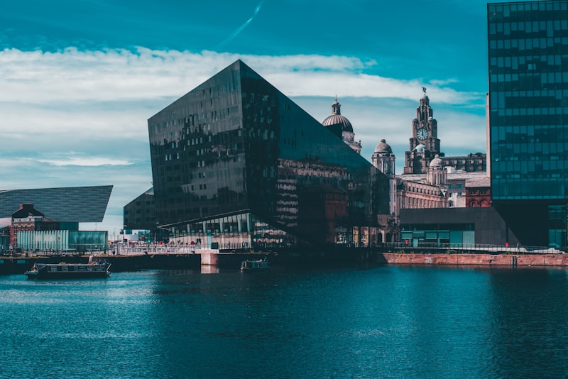 Royal Albert Dock warehouses and clock tower reflected in the dock water, Liverpool waterfront