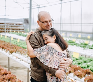 man hugging woman inside garden house