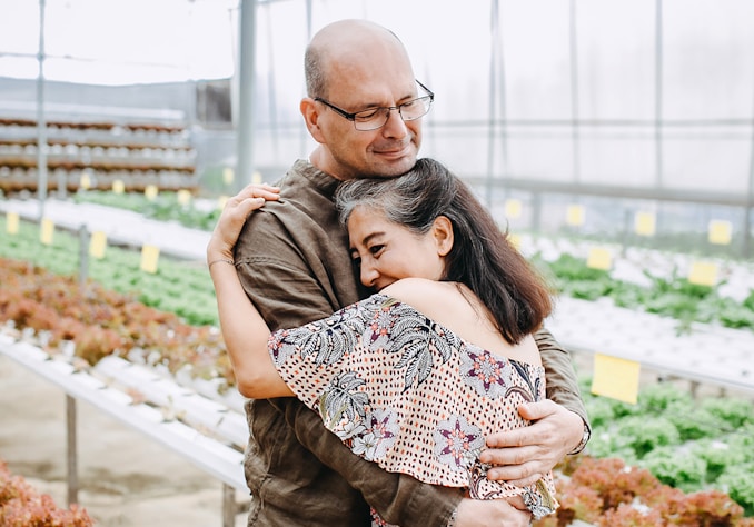 man hugging woman inside garden house