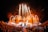 A large outdoor concert at night features bright stage lights and fireworks shooting into the sky, surrounded by a massive crowd of people. The stage has intricate designs with glowing elements, and there is an atmosphere of high energy and excitement as the audience focuses on the performance.