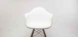 Elegant mid-century modern chair set against a plain white background.