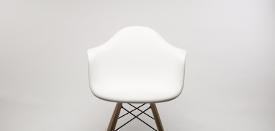Elegant mid-century modern chair set against a plain white background.