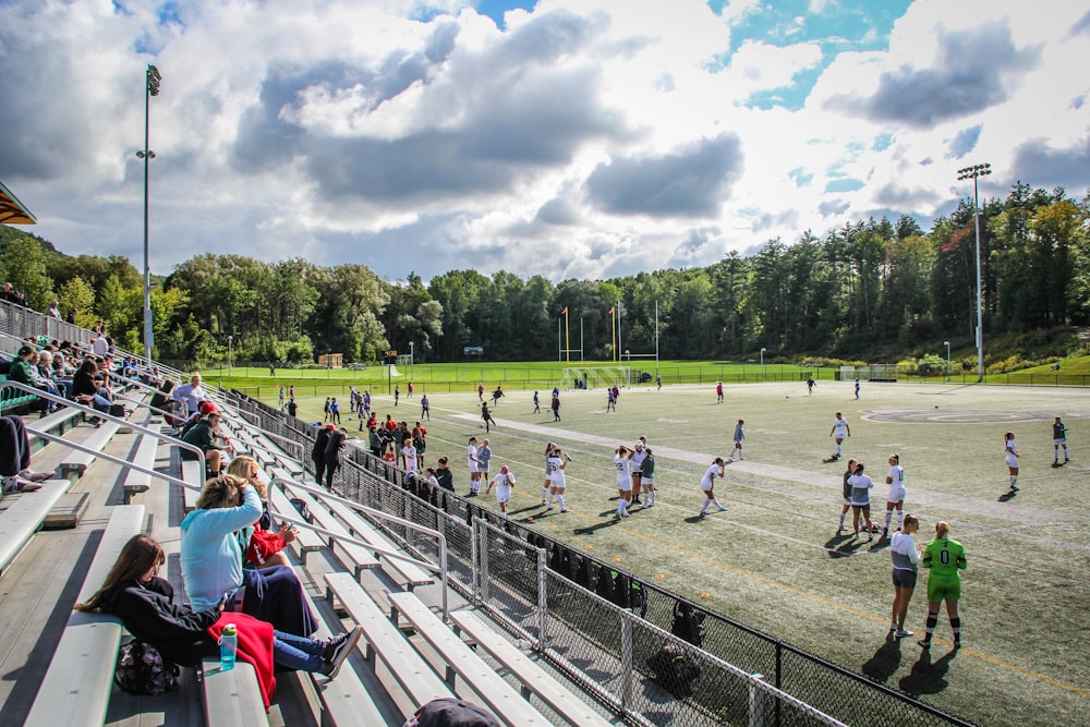 spectators on benches watching the game