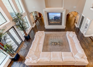 white sectional sofa in front of fireplace inside house