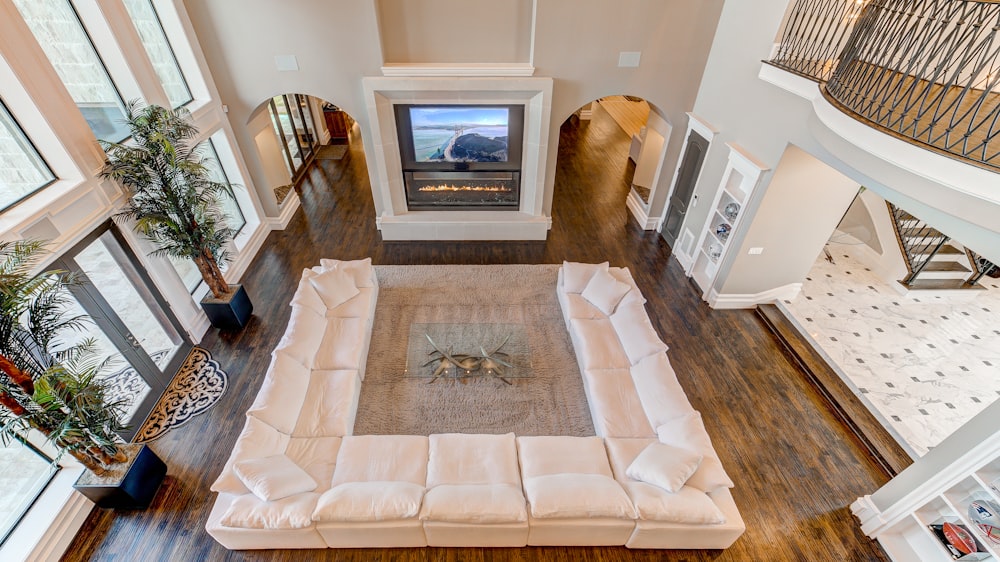 white sectional sofa in front of fireplace inside house