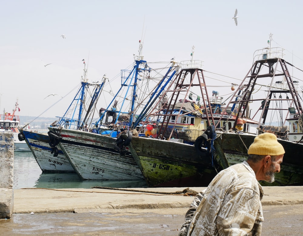 man walking near boat ships during daytime