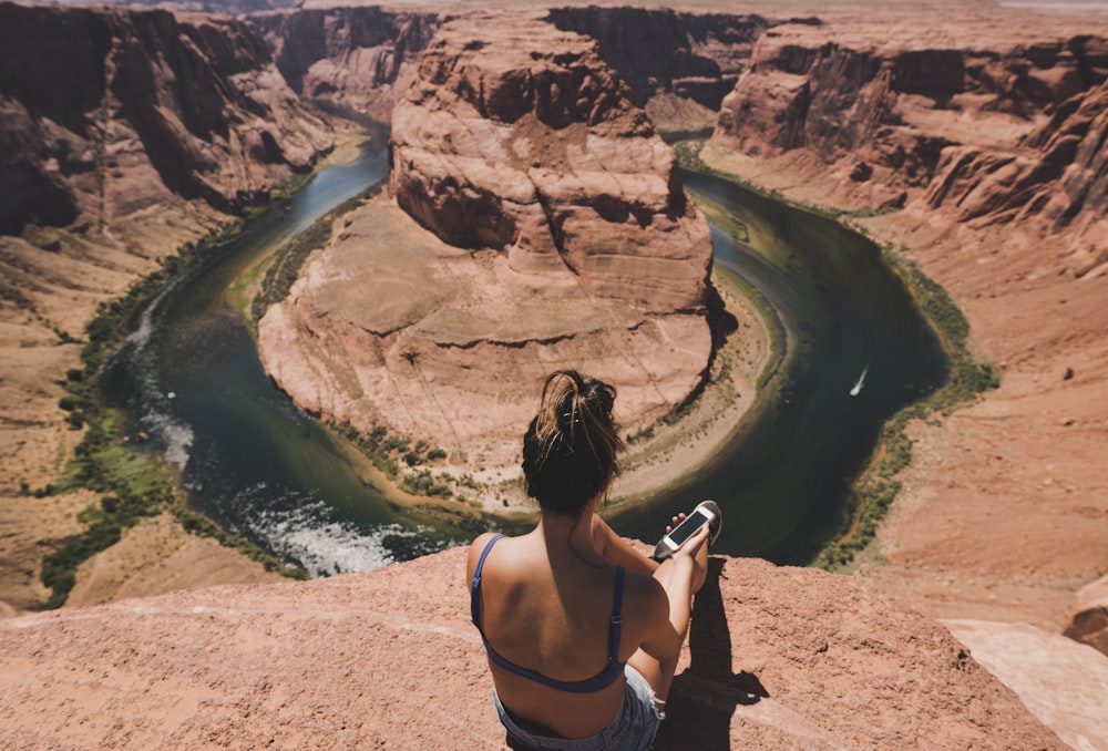 woman sitting in front of Horseshoe Bend, Arizona