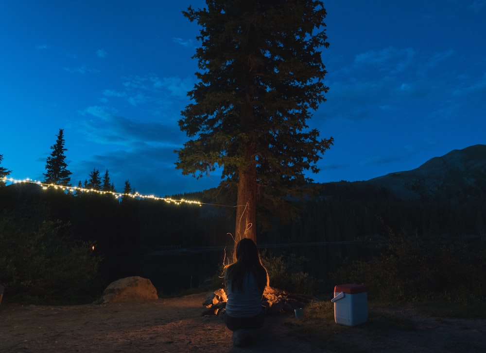 woman sitting in front of tree