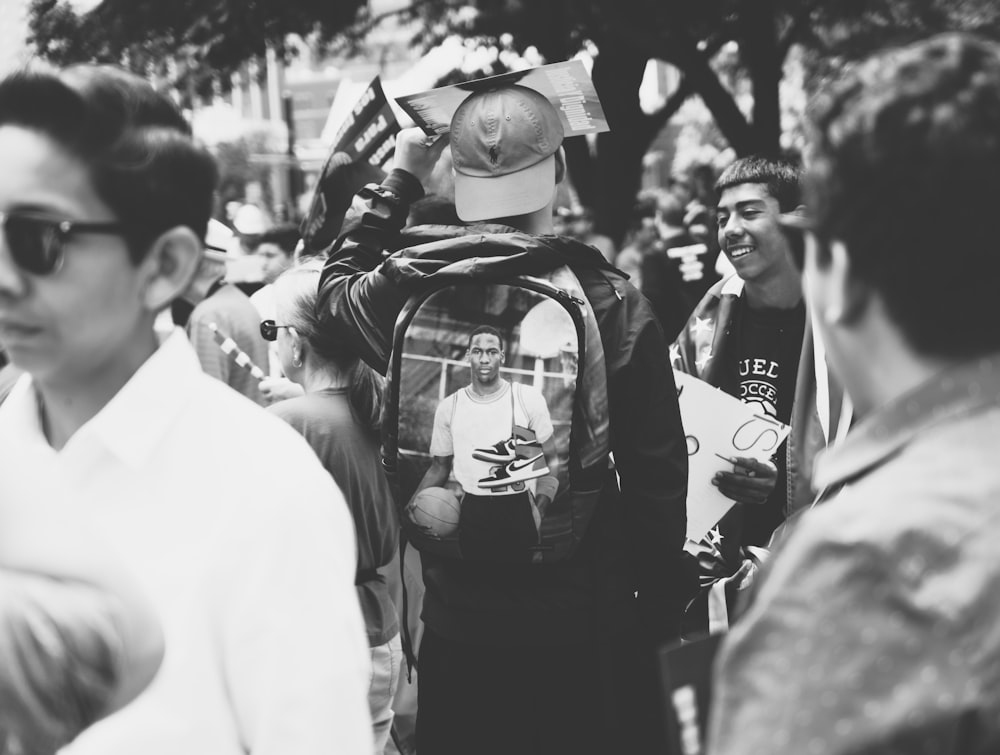 man wearing backpack near people