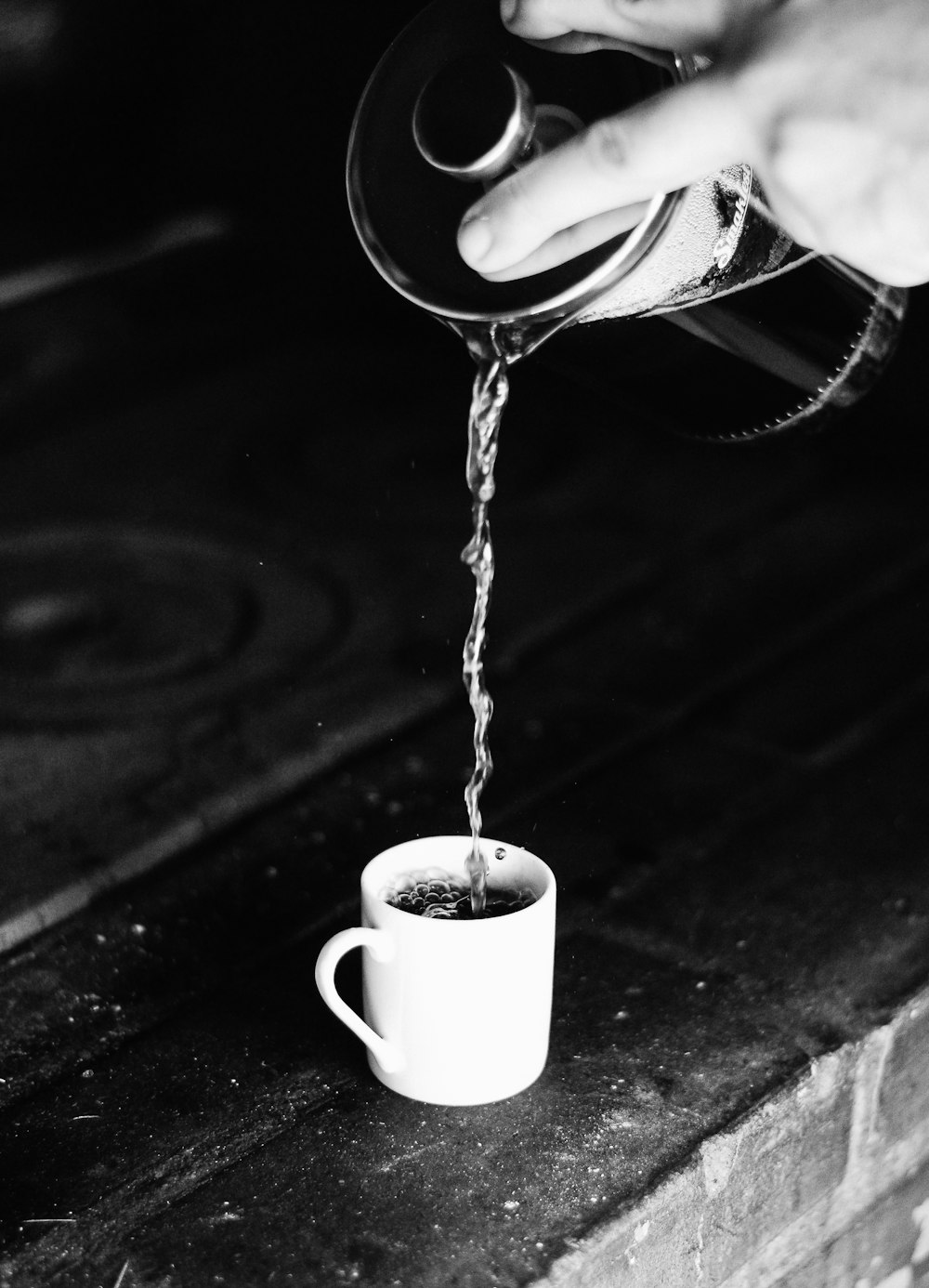 person pouring beverage on mug