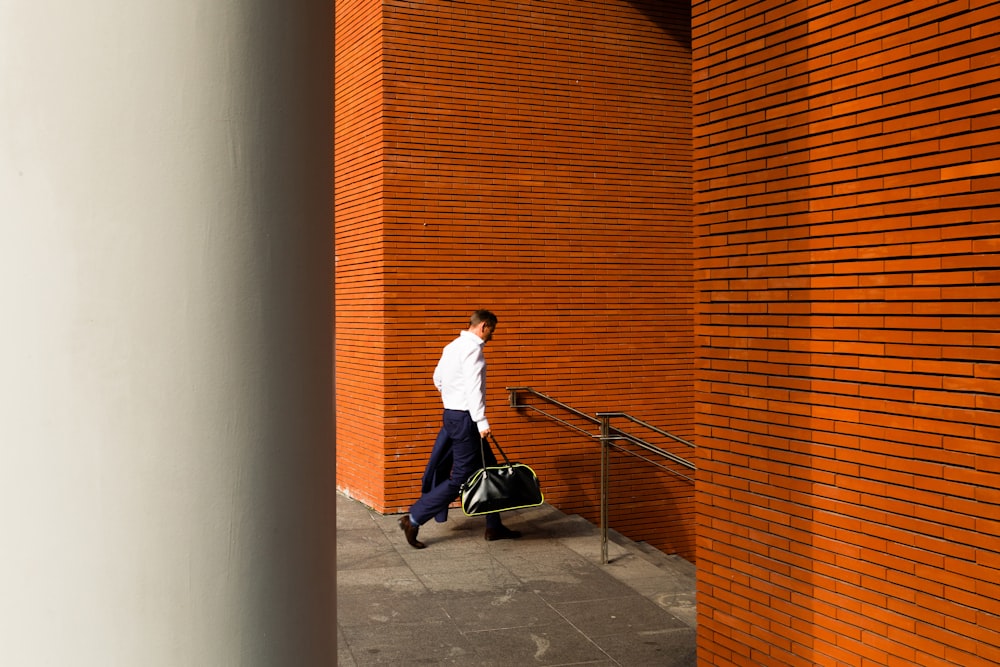 man holding duffel bag down stair