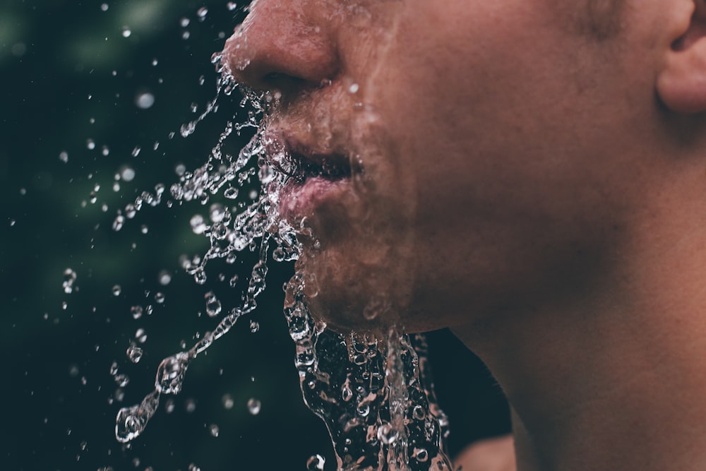 man face with water droplets