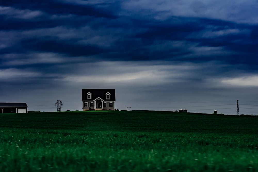 brown and white house on clear under blue cloudy skies