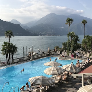 An elegant luxury resort poolside scene with mountain views.
