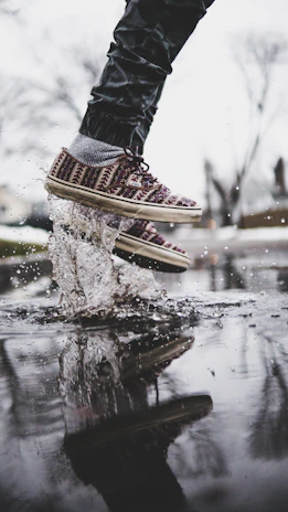 Close-up of feet in motion during a salsa on2 class with subtle splash textures background