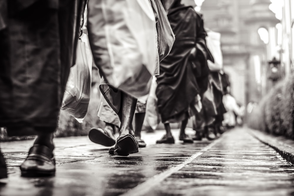 selective focus graysclae photography of people walking on street