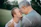 two man talking to each other on grass field