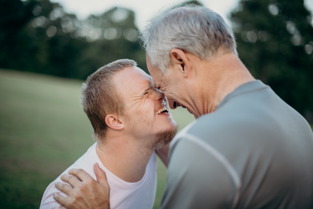 two man talking to each other on grass field