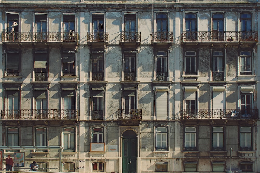 brown concrete building with green door close