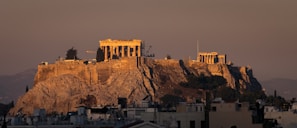 The ark structure rising amidst Nepal's landscape, bathed in warm golden sunlight at dusk.