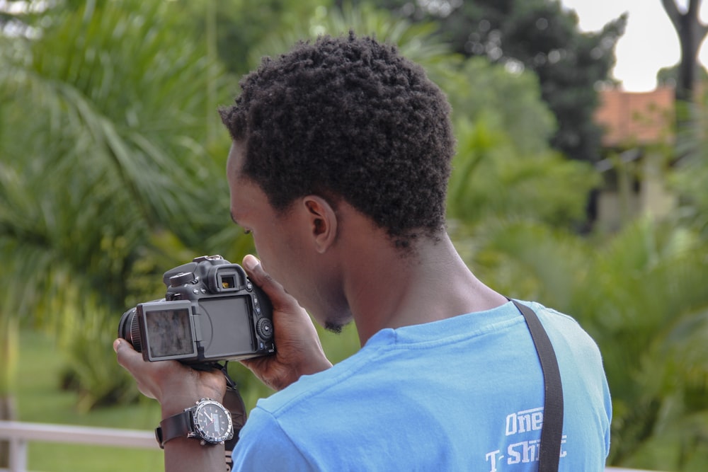 man holding camera photo