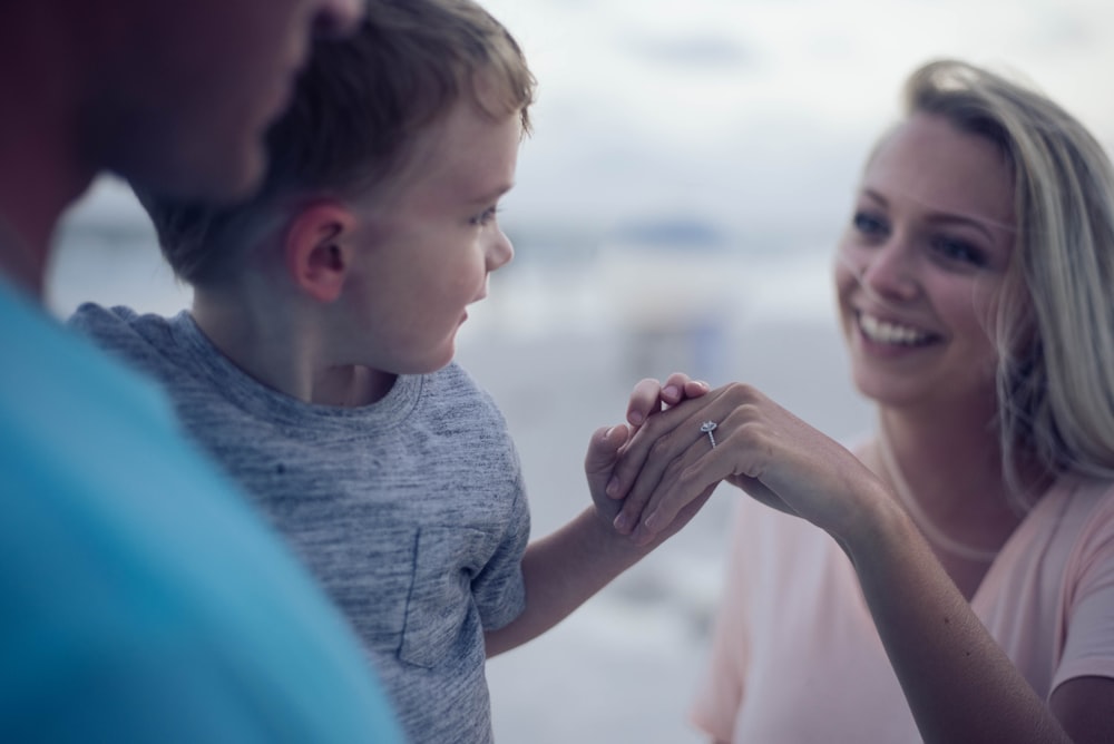 boy holding womans hand