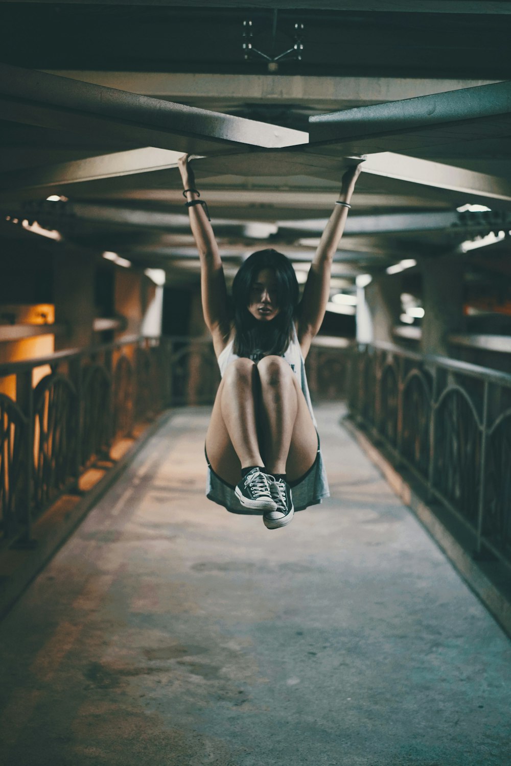 woman hanging on x shape ceiling