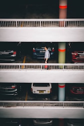 man standing behind vehicles