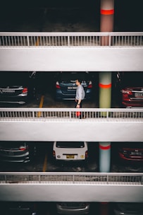 man standing behind vehicles