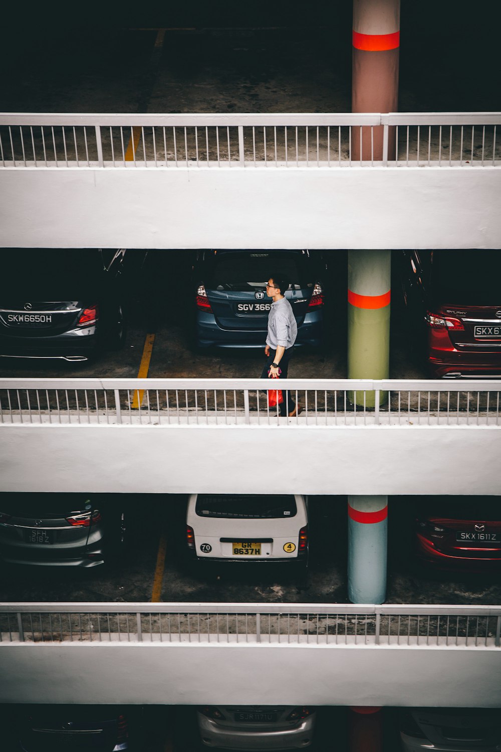 man standing behind vehicles