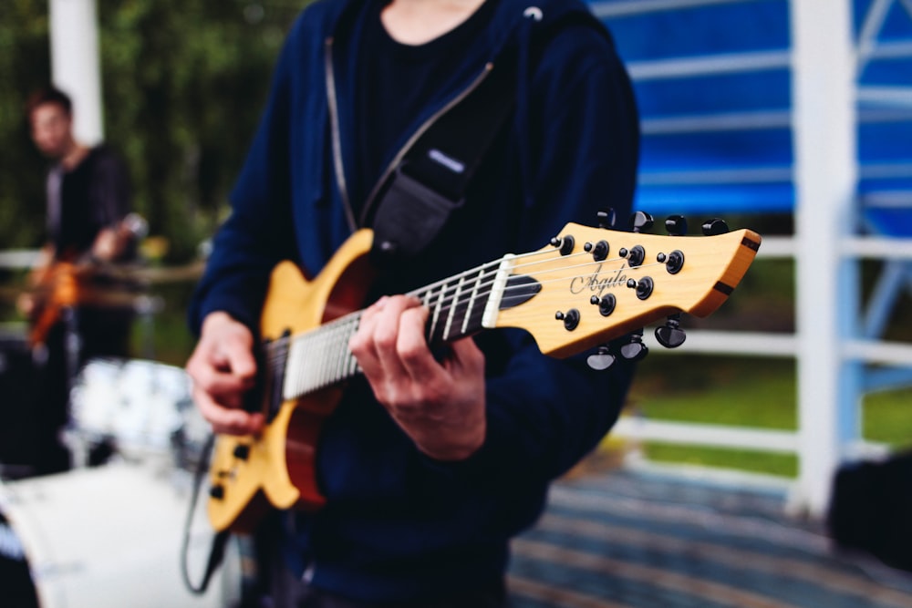 person playing electric guitar