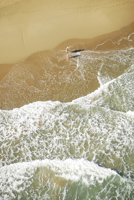 person walking on seashore waves in Cabarete Dominican Republic