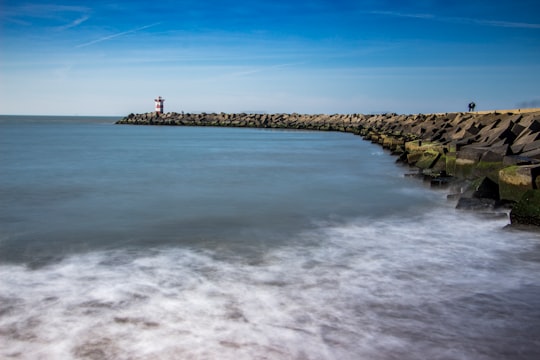 lighthouse near body of water in Scheveningen Netherlands
