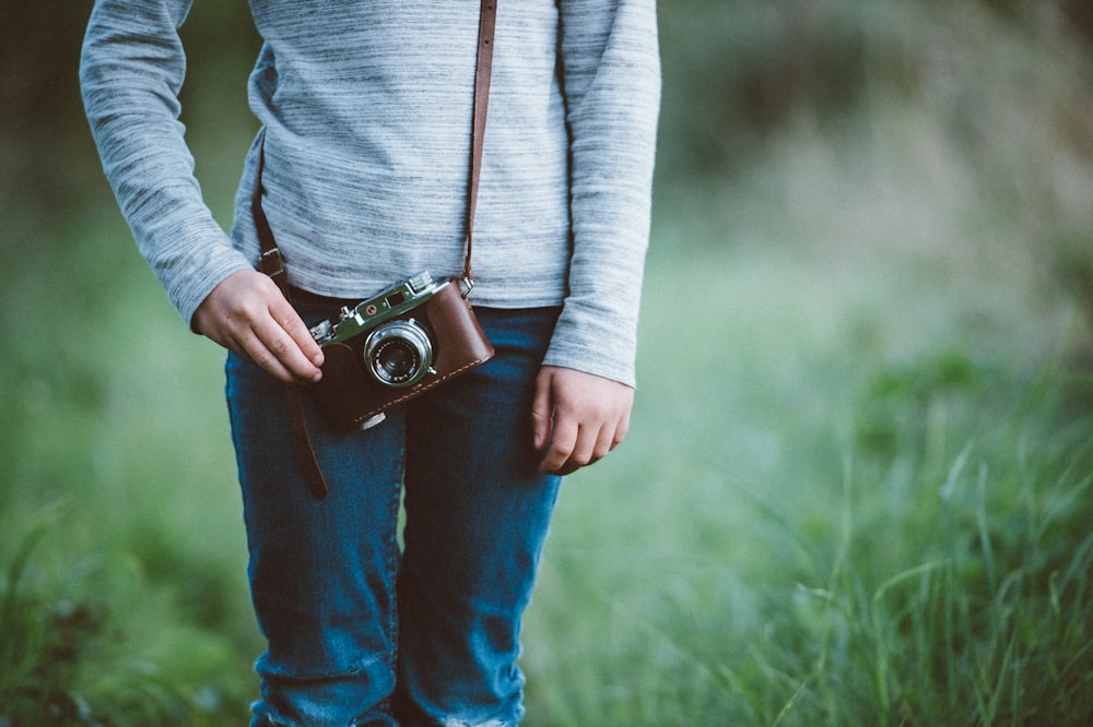 standing person with camera at the field during day