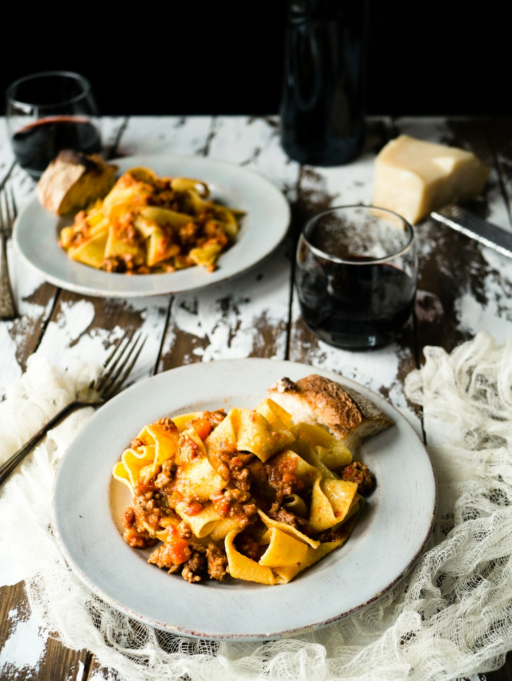 pasta on white plate near glass