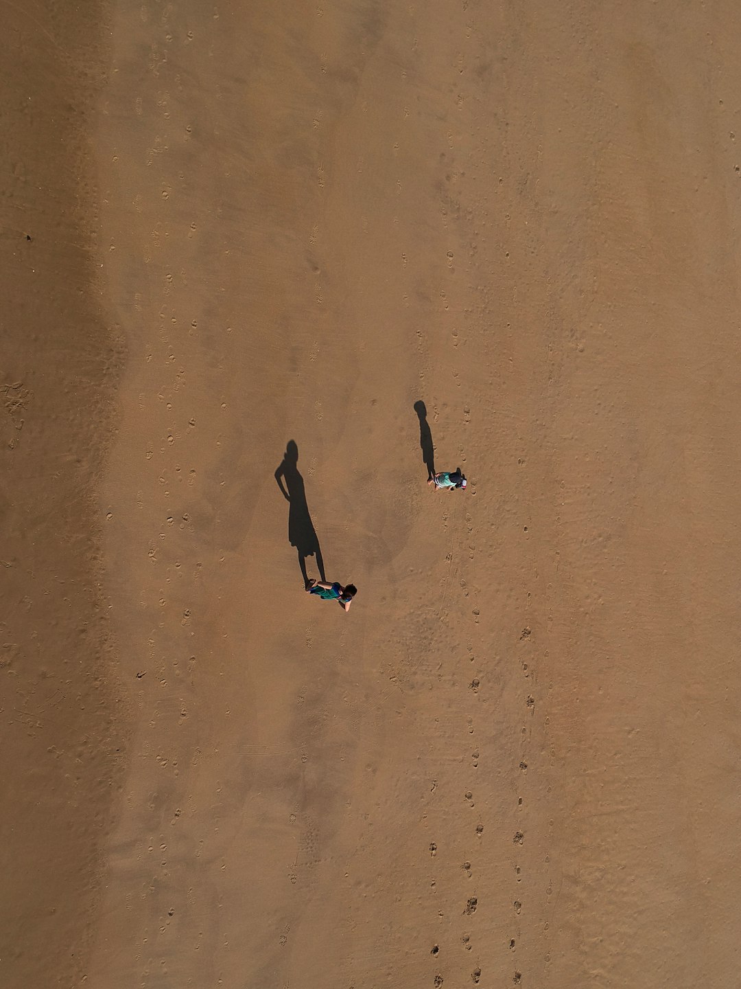 two person standing on desert at daytime