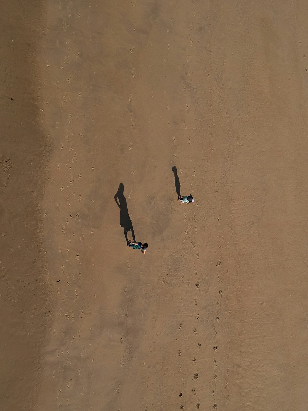 two person standing on desert at daytime
