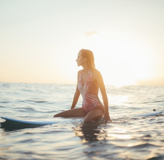 woman riding a blue surfboard in a body of water