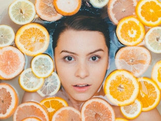 woman surrounded by sliced lemons