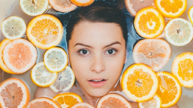 woman surrounded by sliced lemons