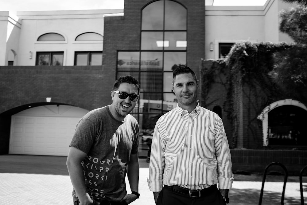 grayscale photography of two smiling men