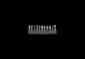 Set of precision screwdrivers neatly arranged on a white surface