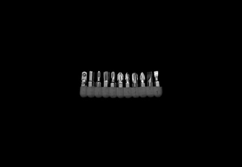 Set of precision screwdrivers neatly arranged on a white surface