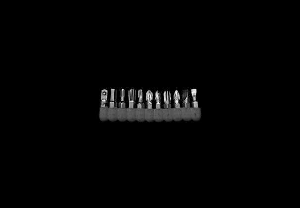 An elegant set of precision screwdrivers arranged neatly on a soft fabric background.