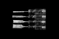 A set of sharp chisels neatly arranged with polished wooden handles gleaming under soft light.