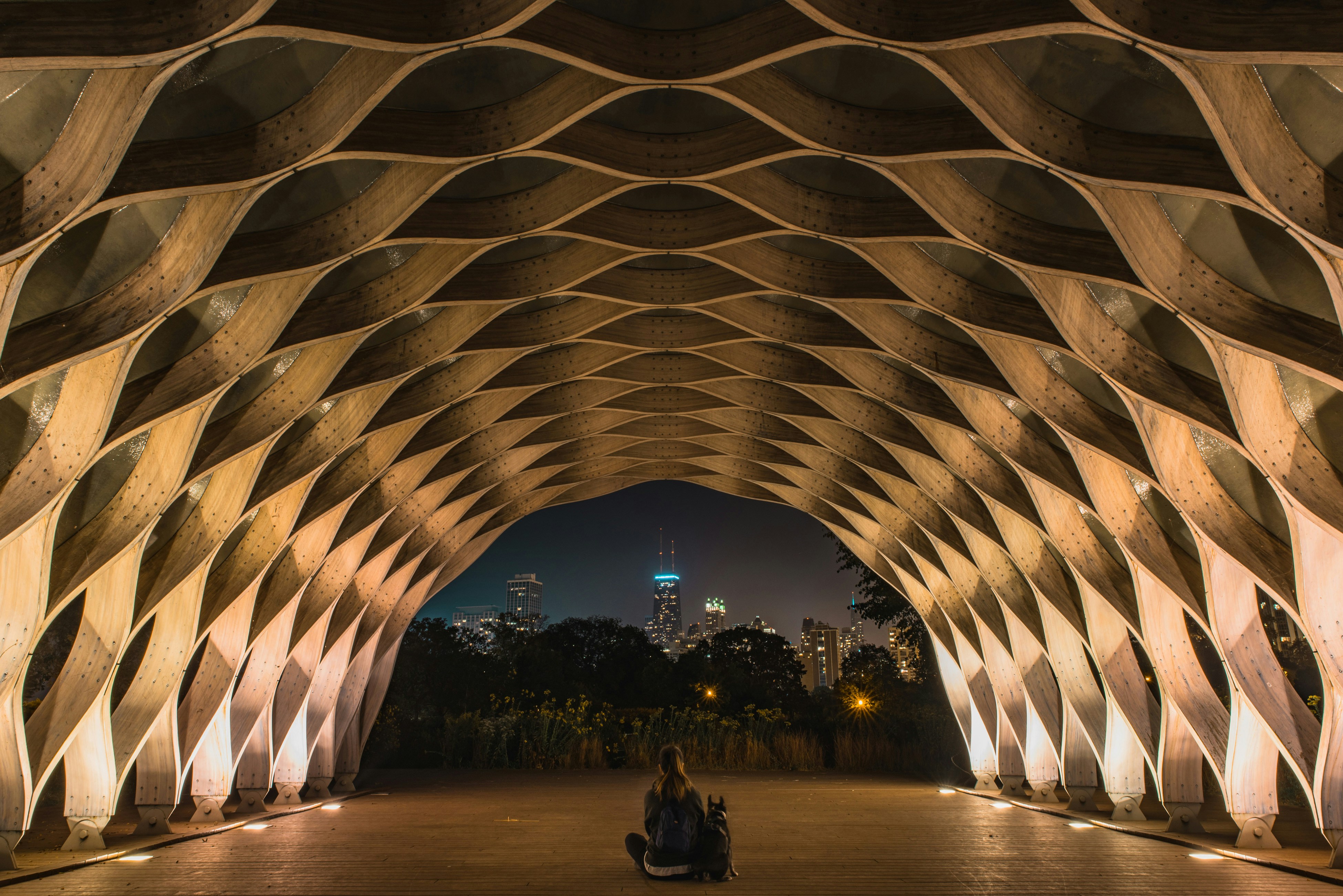 person sitting inside a brown tunnel