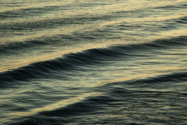 A serene guided soundscape scene showing calming waves and soft lights on a mobile app.