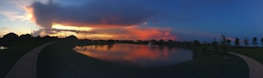 A scenic view of a Minnesota lake with homes along the shoreline at sunset.