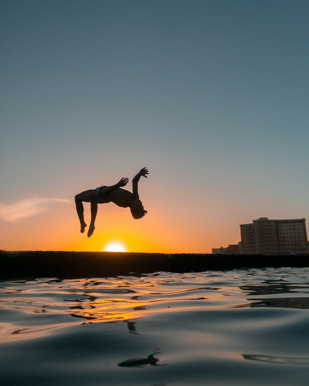 closeup photo of man performing back flip