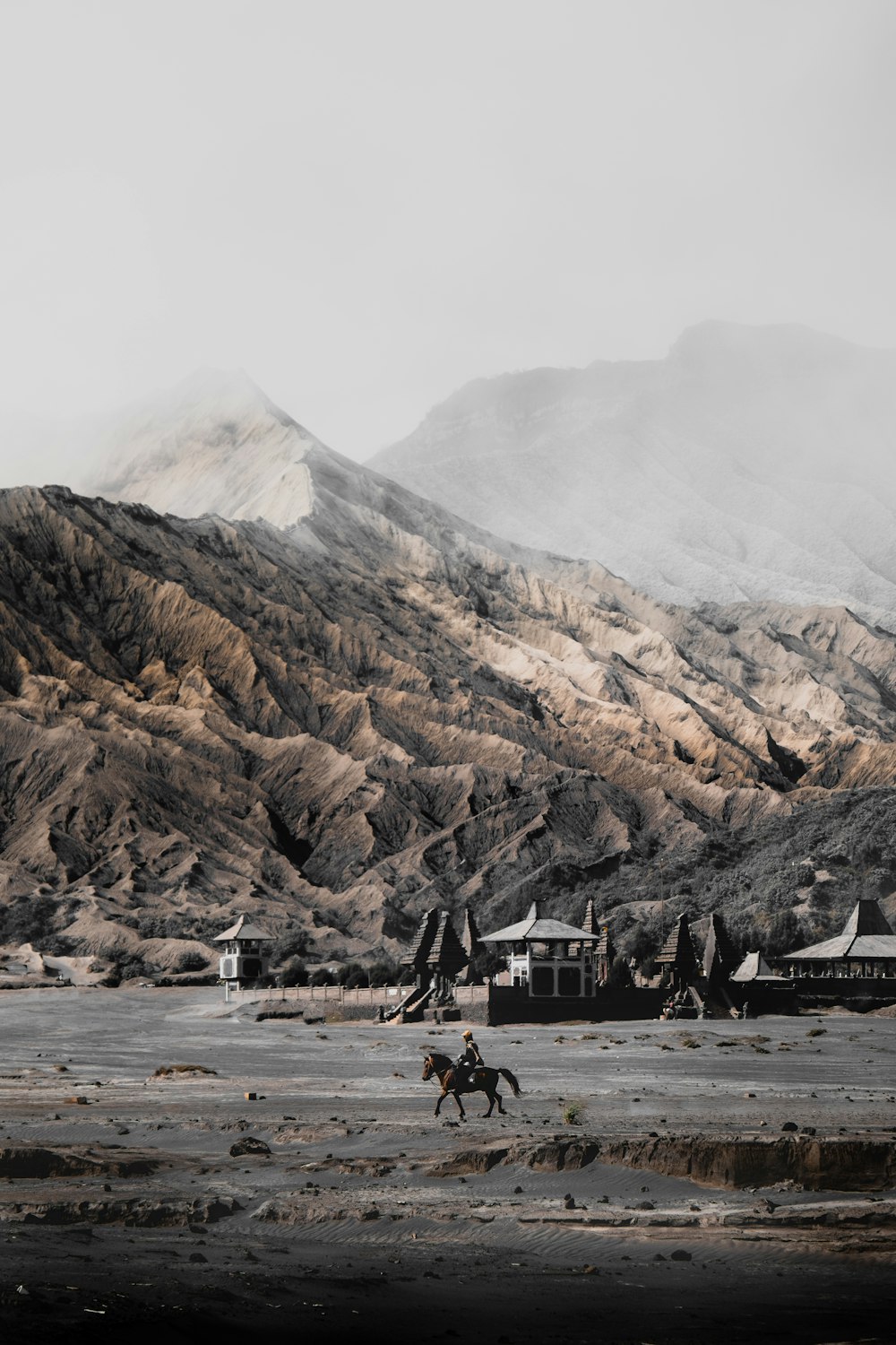 person riding horse near mountain range